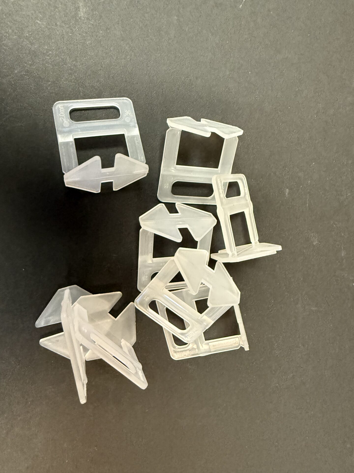 Group of TileFixer clear Wedge Levelling clips