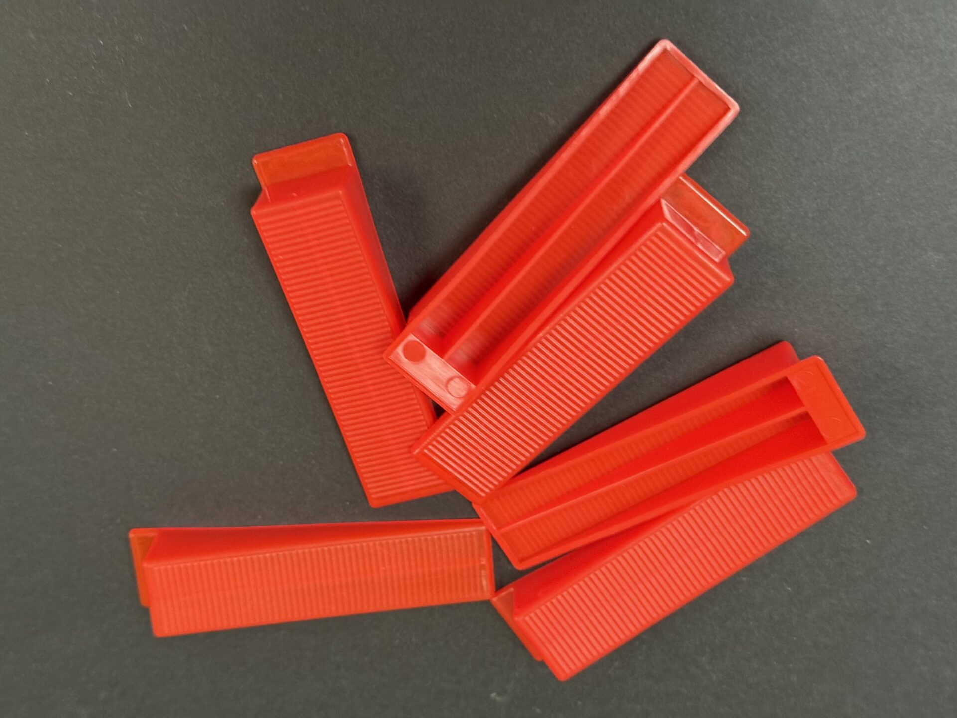 Red ridged TileFixer levelling wedges